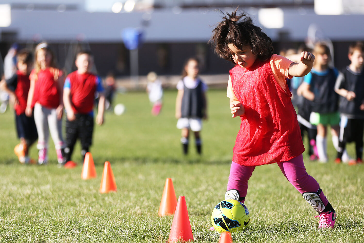 Nevaeh Young dribbles the ball between two cones